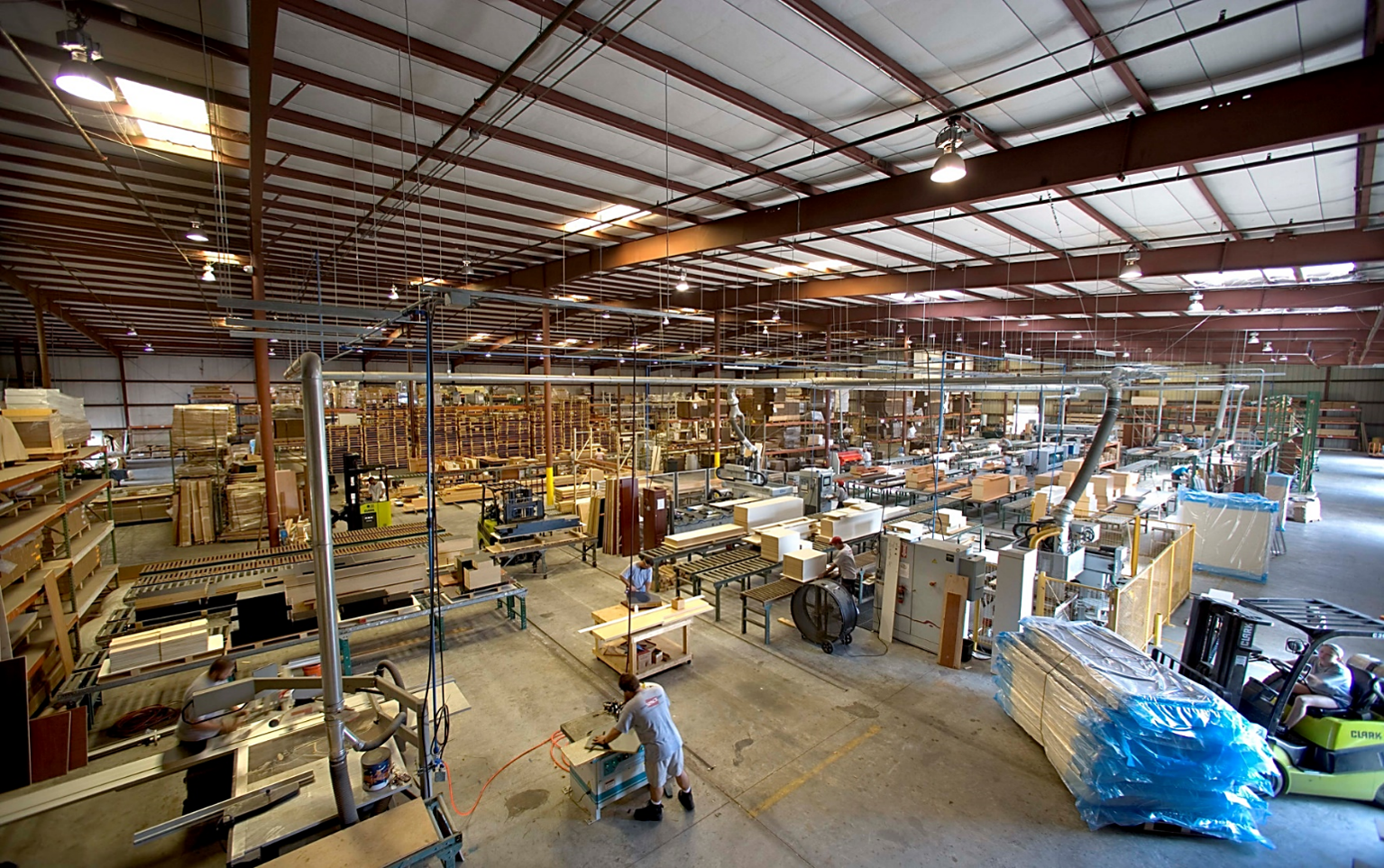 Interior of More Space Place custom cabinetry manufacturing facility in Clearwater Florida showing active production floor with cabinet components and woodworking equipment